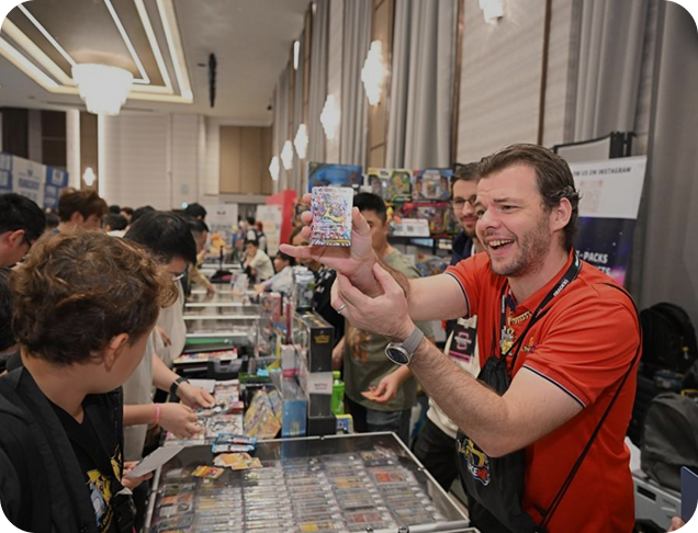 Vendor showing cards to visitors at a branded stand