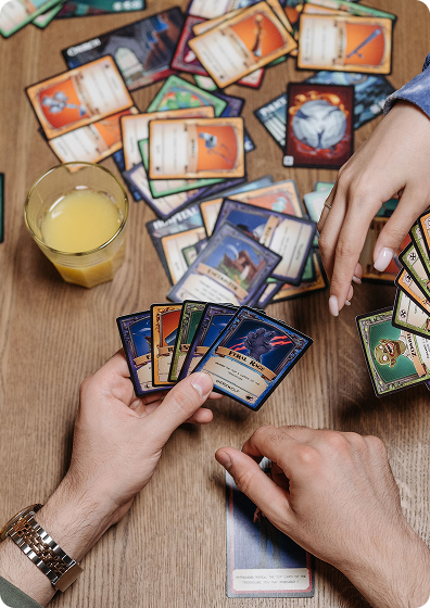 Friends playing and trading cards together around a wooden table