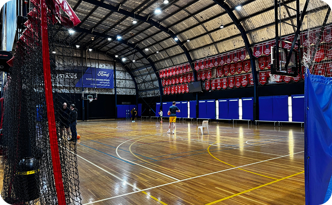 Interior of Norths Basketball stadium with timber court and championship banners