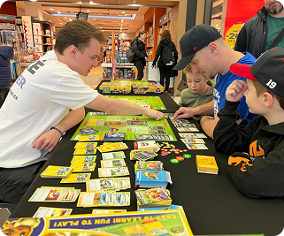 A demonstrator teaching newcomers how to play the trading card game